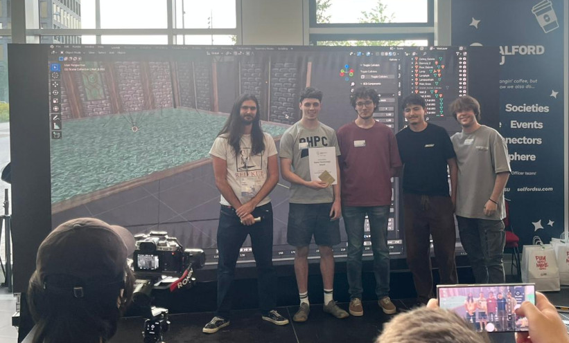 Next to one of the judges from RedKite are team members Liam Swarbrick, Jaime Gine Paraiso, Pio Canas Toimil and FInley Byrne. In the background, a display is showing an image from their game HellMist in the Killswitch engine.